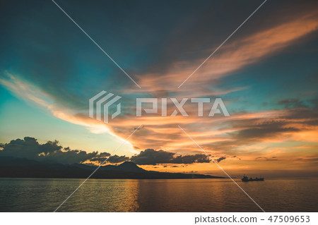 Colorful sunset sky over the Komodo island shore. Colorful sunset sky over the Komodo island shore. 47509653