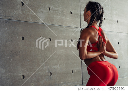 Close up fit woman with arms behind back doing stretching exercises. Close up fit woman with arms behind back doing stretching exercises. 47509691