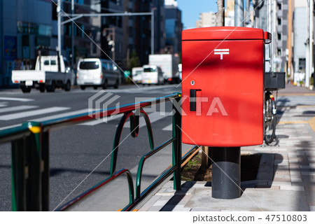 Mail post on the sidewalk of the city 47510803