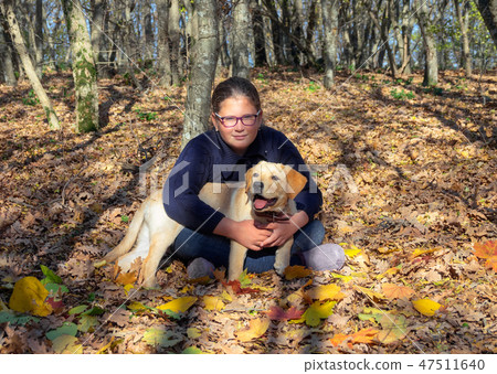 Portrait of girl with dog in autumn forest Portrait of girl with dog in autumn forest 47511640