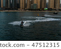 a man on the aqua bike, urban beach background 47512315