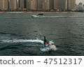 a man on the aqua bike, urban beach background 47512317