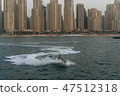 a man on the aqua bike, urban beach background 47512318