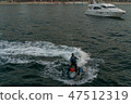 a man on the aqua bike, urban beach background 47512319