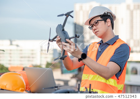 Asian worker man using drone for site survey 47512343