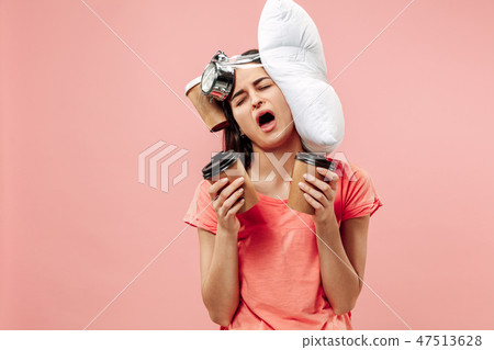 Tired woman at home having too much work. Bored businesslady with pillow and coffee Tired woman at home having too much work. Bored businesslady with pillow and coffee 47513628