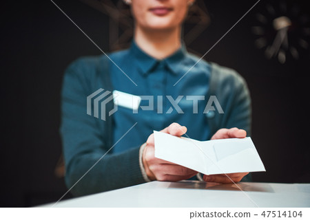 Picture of receptionist giving key card to a client Picture of receptionist giving key card to a client 47514104