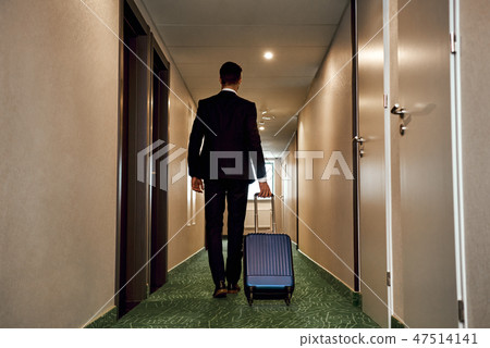 People and technology concept - happy young man with travel bag. Rear view People and technology concept - happy young man with travel bag. Rear view 47514141
