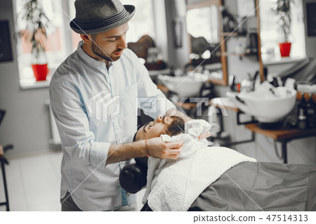 The man cuts his beard in the barbershop 47514313