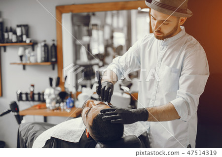 The man cuts his beard in the barbershop 47514319