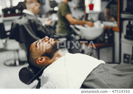 The man cuts his beard in the barbershop The man cuts his beard in the barbershop 47514350