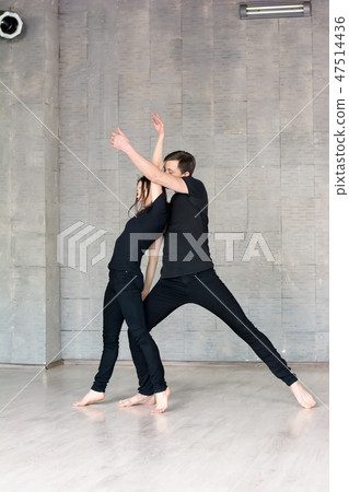 Young couple in black is dancing. 47514436