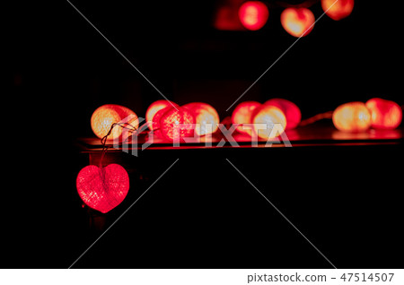 Closeup heart shape of led lights in dark room Closeup heart shape of led lights in dark room 47514507