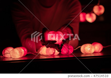 Man holds the led light lamp of heart shape Man holds the led light lamp of heart shape 47514510