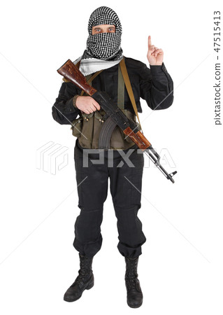 insurgent dressed in black uniform and black and white shemagh with AK 47 rifle insurgent dressed in black uniform and black and white shemagh with AK 47 rifle 47515413