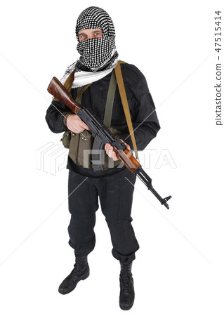 insurgent dressed in black uniform and black and white shemagh with AK 47 rifle 47515414