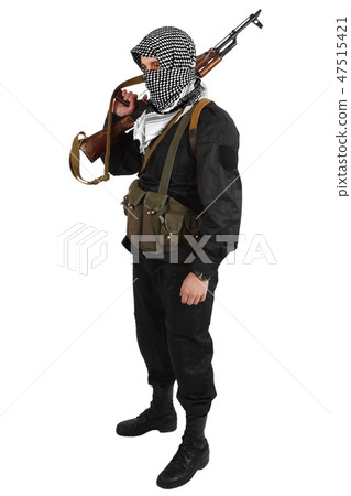 insurgent dressed in black uniform and black and white shemagh with AK 47 rifle 47515421