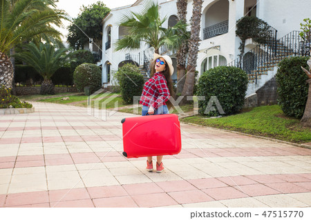 Traveling vacation, holidays, trip and people concept - woman tourist standing with suitcase when 47515770