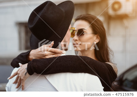 A young, sexy couple of lovers pose for a camera on the streets 47515976