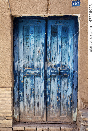 Old antique closed damaged blue door, Yazd, Iran. Old antique closed damaged blue door, Yazd, Iran. 47516008