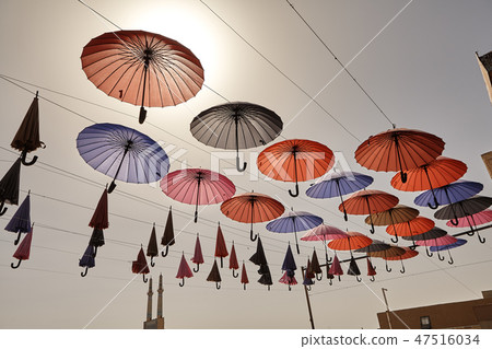 Colorful umbrellas hanging from the sky background 47516034