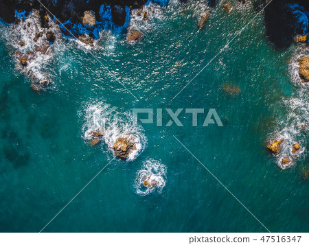 Drone top view of a sea cliff and a beach 47516347