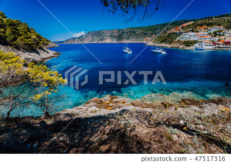 Amazing Greece, white sail boats in blue bay of picturesque colorful village Assos in Kefalonia Amazing Greece, white sail boats in blue bay of picturesque colorful village Assos in Kefalonia 47517316