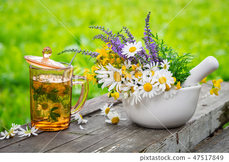 Herbal tea cup, mortar of herbs on wooden board. Herbal tea cup, mortar of herbs on wooden board. 47517849