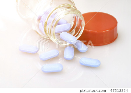 Blue caplets on white background. 47518234