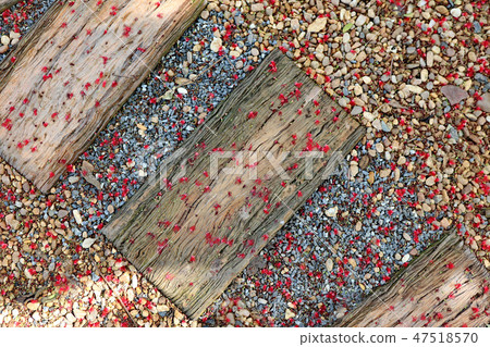 Red fall pollen scattered on the gravel and stone Red fall pollen scattered on the gravel and stone 47518570