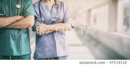 Doctor and surgeon with arms crossed in hospital. Doctor and surgeon with arms crossed in hospital. 47519316
