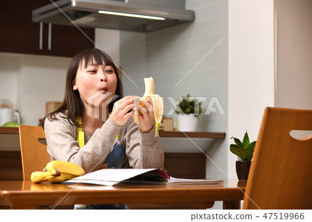 A housewife who is self-defeated in the kitchen and eats bananas A housewife who is self-defeated in the kitchen and eats bananas 47519966