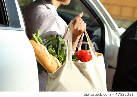 A housewife who has been shopping at the supermarket A housewife who has been shopping at the supermarket 47522381