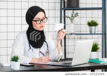 View of young muslim doctor with box of pills medicines 47523164