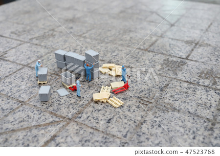 a mini worker figure using a trolley a mini worker figure using a trolley 47523768