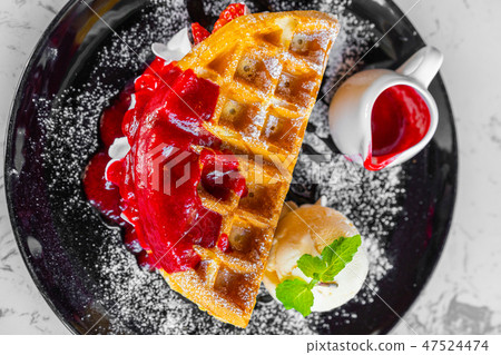 Waffles with strawberry and Vanilla Ice Cream 47524474