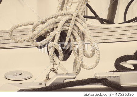 Yachting concept, Coiled rope on sailboat 47526350