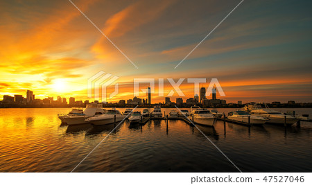 Sunrise over Boston city with boat and harbor 47527046