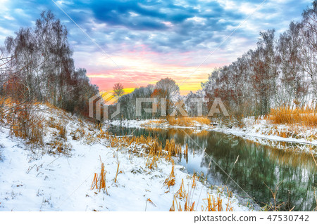 Winter landscape by a river in the sunset Winter landscape by a river in the sunset 47530742