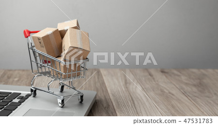 Delivery of the order from the online store. Online shopping. Boxes with goods in the shopping Delivery of the order from the online store. Online shopping. Boxes with goods in the shopping 47531783