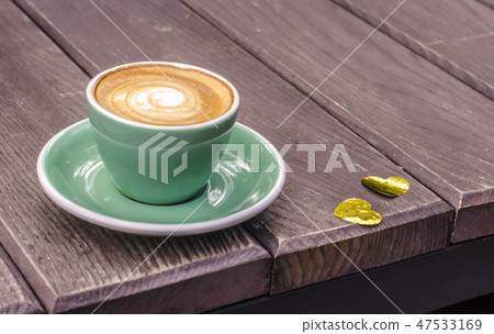 Turquoise Latte Cup on a wooden background Turquoise Latte Cup on a wooden background 47533169