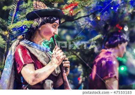 Wooden statue of a shepherd with a pipe. Wooden statue of a shepherd with a pipe. 47533183