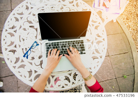 Top view of young working woman using laptop Top view of young working woman using laptop 47533196
