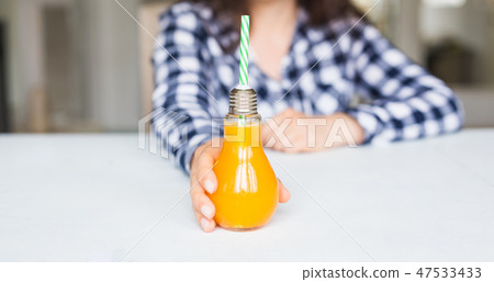 Drinks, diet and healthy lifestyle concept - woman giving you a bottle of natural juice 47533433