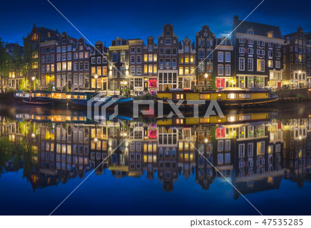 Cityscape of Amsterdam at night with reflection of buildings on water Cityscape of Amsterdam at night with reflection of buildings on water 47535285