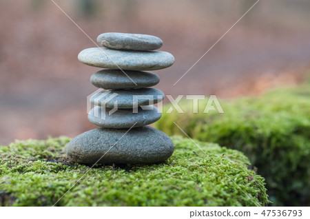 Closeup of stone balance on moss in the forest 47536793