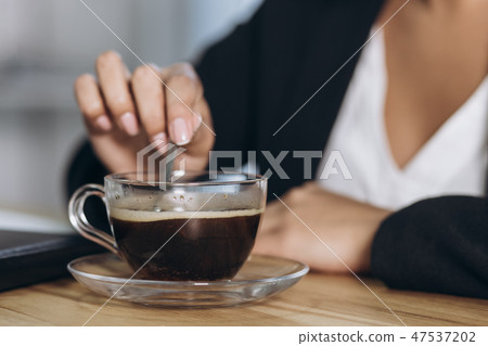 A wooden desktop with a morning black cup of coffee. A wooden desktop with a morning black cup of coffee. 47537202