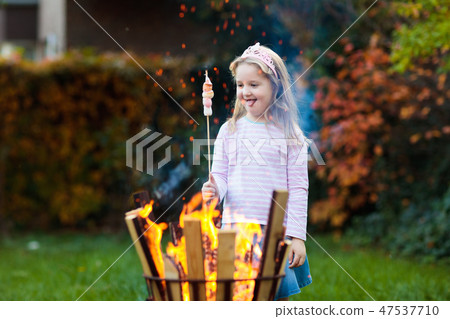 Child with smores at fire. Kids roast marshmallow. Child with smores at fire. Kids roast marshmallow. 47537710
