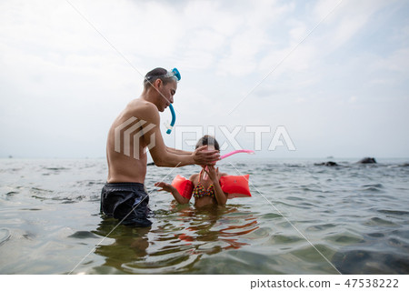 Father teaching daughter snorkeling Father teaching daughter snorkeling 47538222