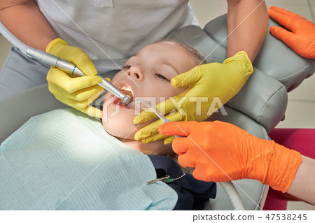 Little girl treating teeth in dentistry clinic. 47538245